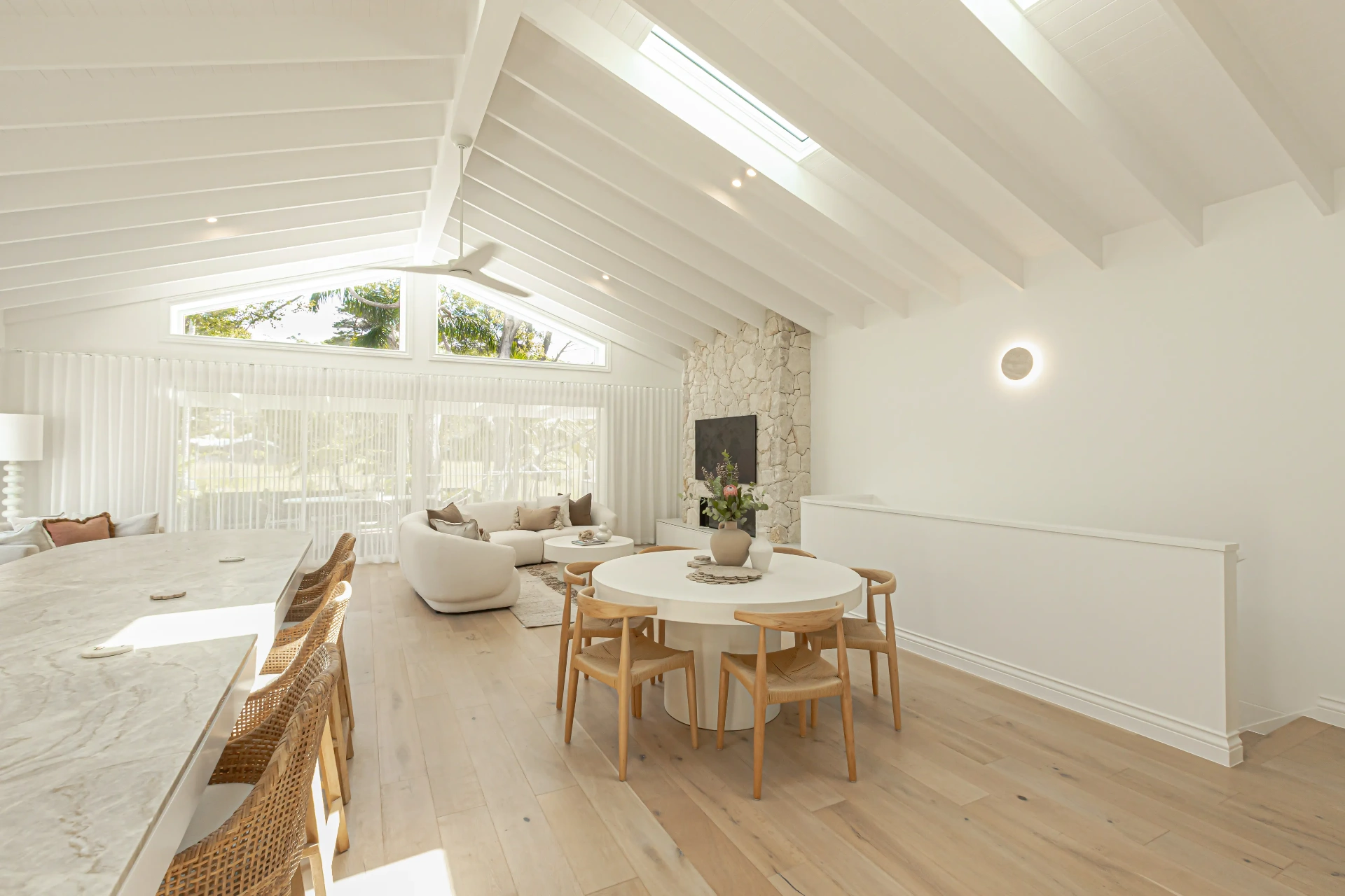 Vaulted living room with skylights and downlights