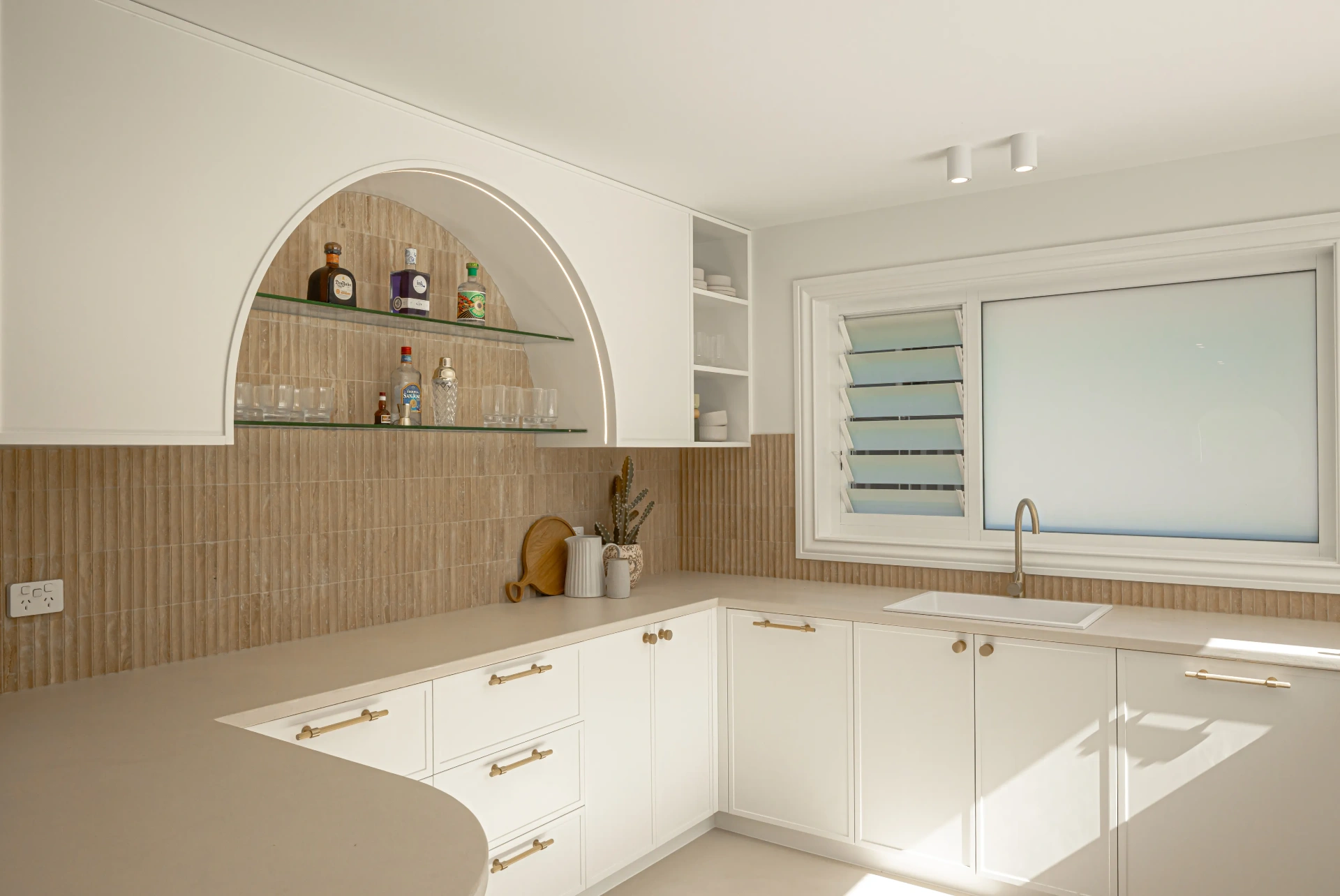 Modern kitchen with arched bar nook and feature LED lighting