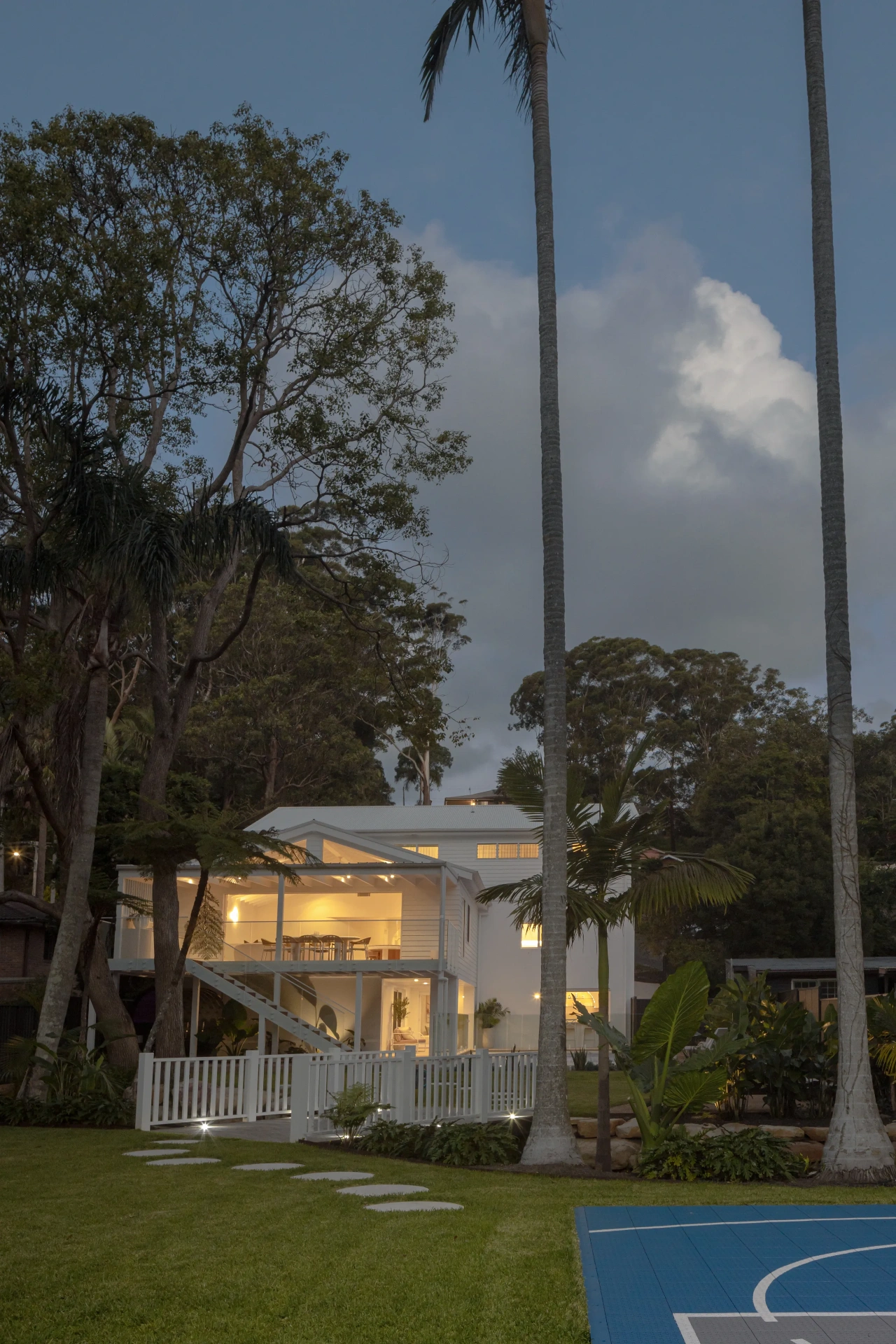 Two-storey Central Coast home exterior at dusk with custom lighting